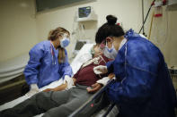 Doctor Veronica Verdino attends to a COVID-19 patient at the Dr. Norberto Raul Piacentini hospital, in Lomas de Zamora, Argentina, Saturday, May 8, 2021. (AP Photo/Natacha Pisarenko)