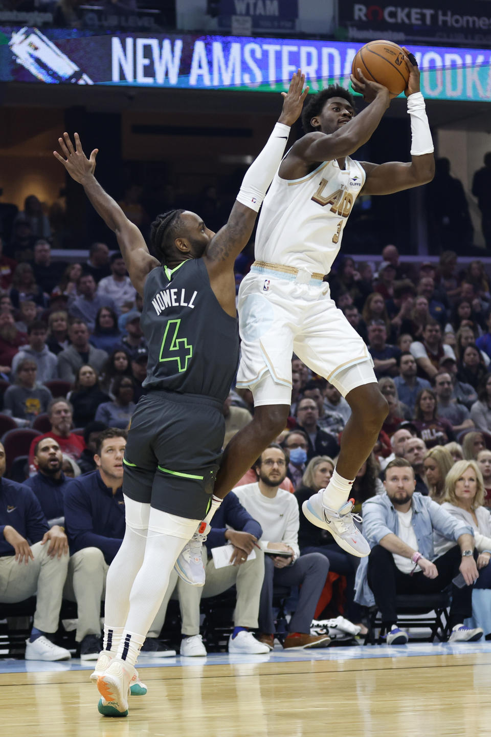 Cleveland Cavaliers guard Caris LeVert (3) shoots against Minnesota Timberwolves guard Jaylen Nowell (4) during the first half of an NBA basketball game, Sunday, Nov. 13, 2022, in Cleveland. (AP Photo/Ron Schwane)