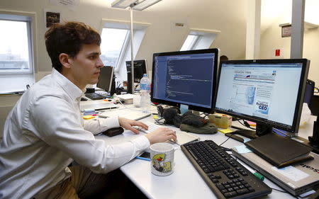 An employee works at the innovation lab of Swiss bank UBS in Zurich January 16, 2015. REUTERS/Arnd Wiegmann/Files