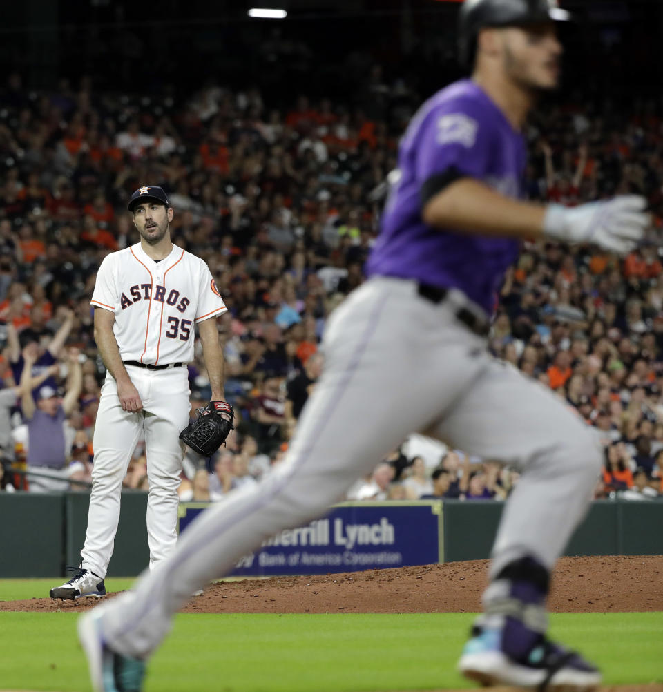 Houston Astros starting pitcher Justin Verlander (35) reacts after Colorado Rockies' Nolan Arenado, right, hit a two-run home run during the sixth inning of a baseball game Tuesday, Aug. 14, 2018, in Houston. (AP Photo/David J. Phillip)