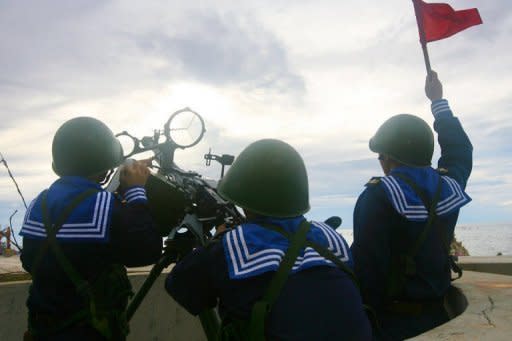 Vietnamese sailors training with a 12.7 mm machine gun on Phan Vinh Island in the Spratly archipelago, June 14. China and Vietnam have pledged to resolve a row over the strategic South China Sea, state media said, in a bid to ease tensions that prompted accusations of Chinese bullying in the region