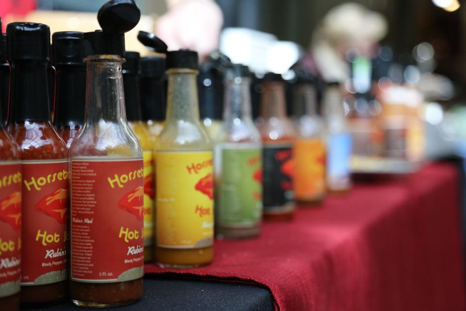 Bottles of Horsetooth Hot Sauce sit at the "Buy Local for Your Love" winter farmer's market at Opera Galleria in Fort Collins.