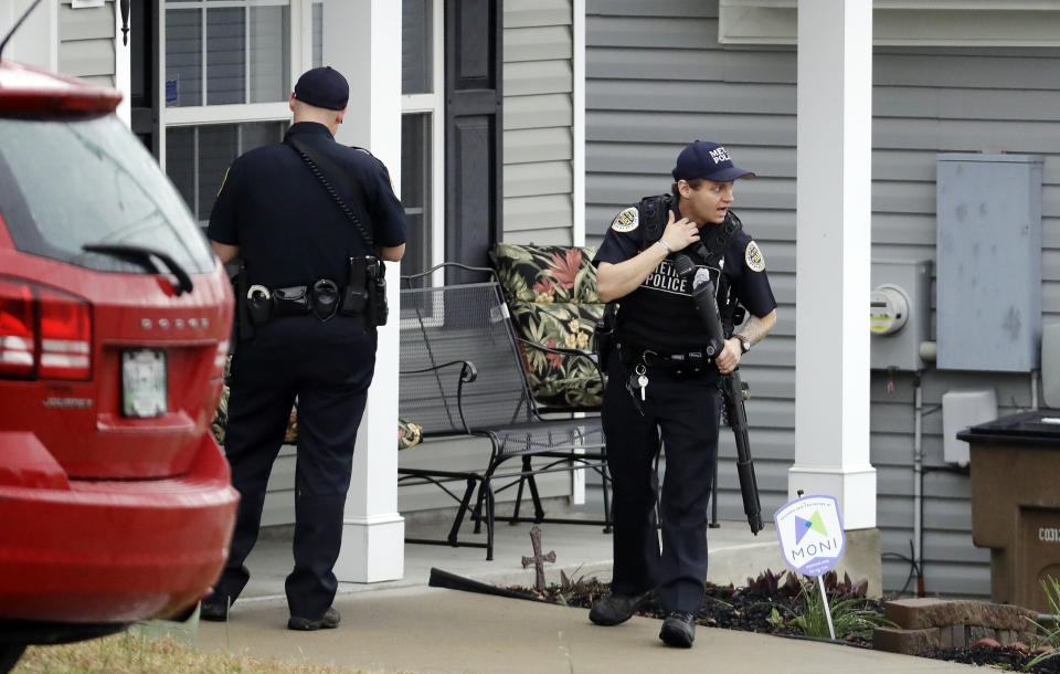 <p>Nashville police officers search a neighborhood near a Waffle House restaurant Sunday, April 22, 2018, in Nashville, Tenn. At least four people died after a gunman opened fire at the restaurant early Sunday. (Photo: Mark Humphrey/AP) </p>