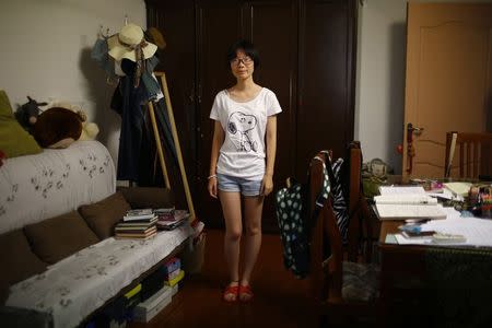 Zhang Xiaoying, who was born in 1998, poses for a photograph in Shanghai August 24, 2014. REUTERS/Carlos Barria