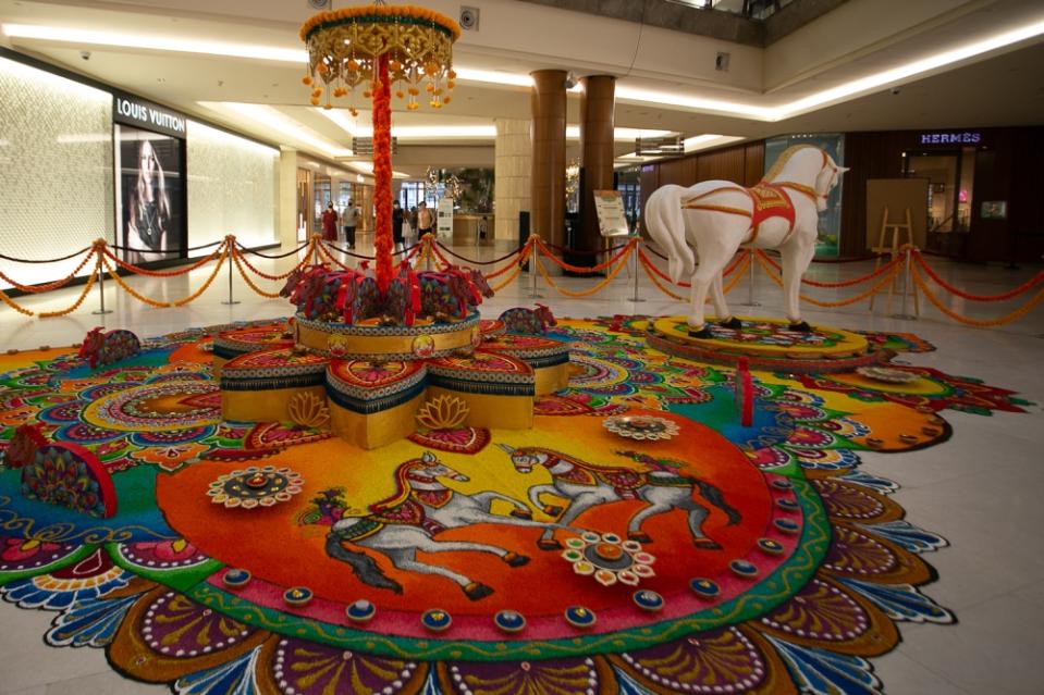 The Gardens Mall draws inspiration from horses for its colourful Kolam, which are meticulously made using coloured rice, rice flour, lentils and white rock powder. — Picture by Raymond Manuel