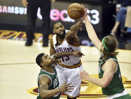 May 23, 2017; Cleveland, OH, USA; Cleveland Cavaliers center Tristan Thompson (13) reaches for a rebound between Boston Celtics guard Marcus Smart (36) and center Kelly Olynyk (41) in the second quarter in game four of the Eastern conference finals of the NBA Playoffs at Quicken Loans Arena. Mandatory Credit: David Richard-USA TODAY Sports