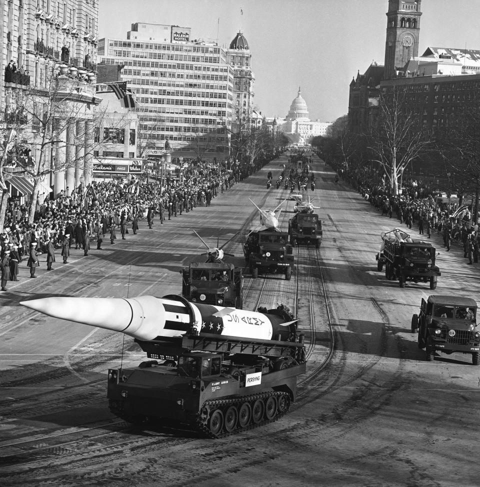 An Army Pershing missile mounted on a tank-like carrier catches the sunlight as the inaugural parade for President John F. Kennedy draws attention of spectators along Pennsylvania Avenue in Washington, Jan. 20, 1961. Other missiles, from front, are: Lacrosse, Nike Hercules and Nike Zeus. This view toward the Capitol was made from a stand at the Treasury Department. (AP Photo)