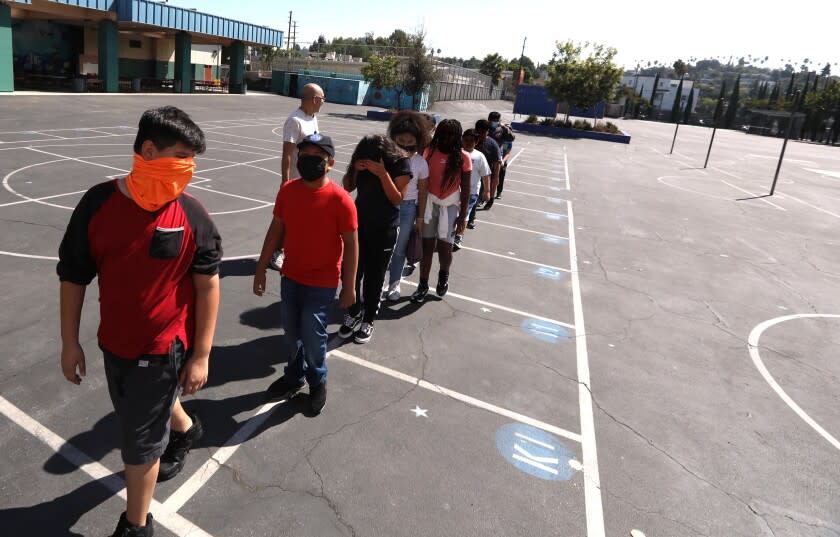 LOS ANGELES, CA - AUGUST 31, 2022 - - Students return to class after a midmorning recess at Lockwood Elementary School on August 31, 2022. With temperatures rising in Los Angeles the principal of the school decided that students would not be allowed to play in the yard in the afternoon due to extreme hot weather. Lockwood Elementary School is the number one school in LAUSD's greening index meaning it is the most in need of green space out of all schools. (Genaro Molina / Los Angeles Times) ATTENTION PRE-PRESS: PLEASE DO NOT LIGHTEN FACES AS TO NOT IDENTIFY STUDENTS.