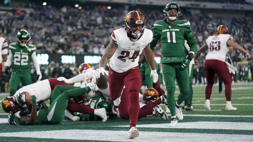 Washington Commanders running back Antonio Gibson (24) reacts as he scores a touchdown against the New York Jets during the fourth quarter of an NFL football game, Sunday, Dec. 24, 2023, in East Rutherford, N.J. (AP Photo/Seth Wenig)