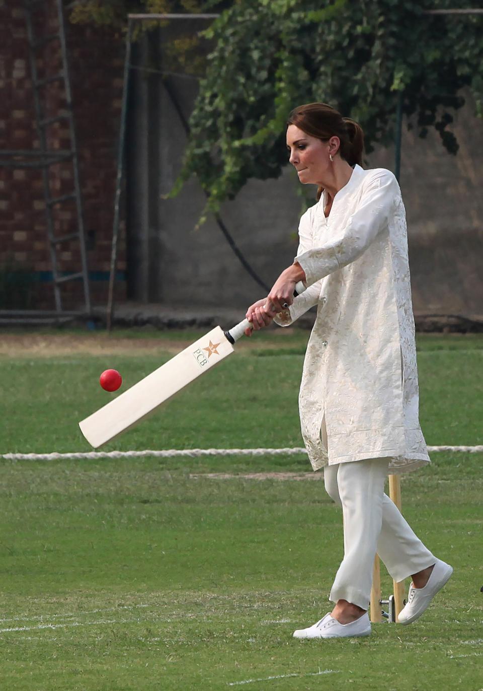 Duchess Kate showed off her cricket skills during a visit to the National Cricket Academy in Lahore, Pakistan, on Oct. 17, 2019. In this picture by the Pakistan Cricket Board, Kate is wearing a traditional tunic-and-pants ensemble in white.