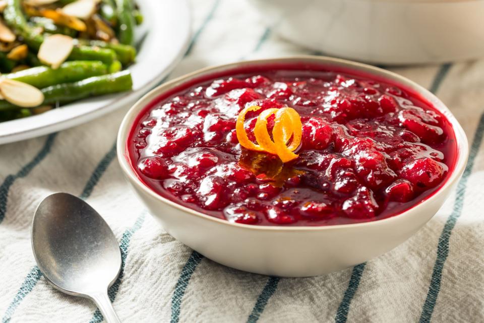 a bowl of homemade cranberry sauce topped with orange zest