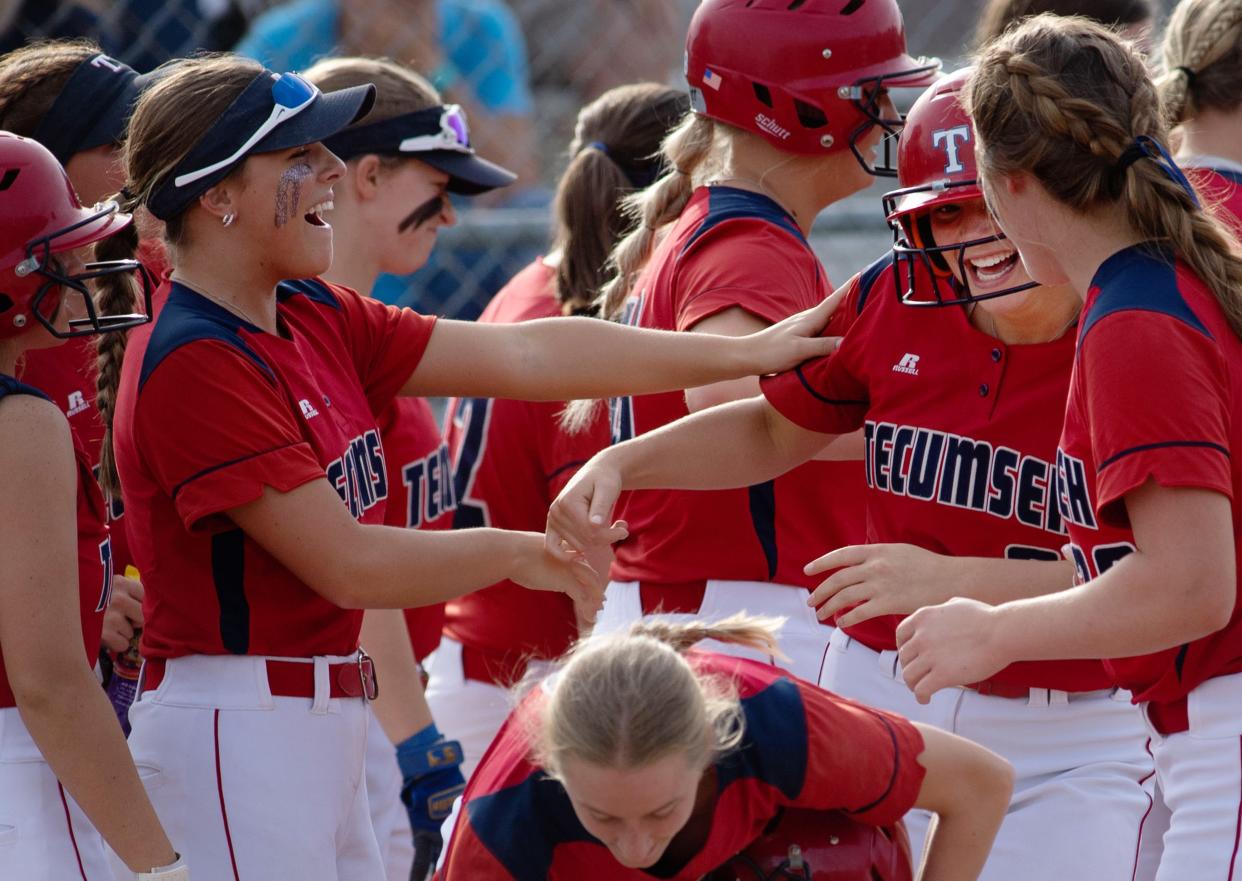 Tecumseh's Jenna Donohoo (6) second right, is congratulated after hitting a home run against Castle during their game at Tecumseh High School Wednesday evening, May 10, 2023. Castle won the game 7-4 in extra innings.