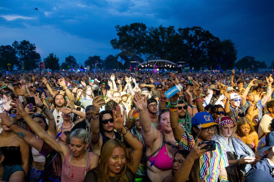 Fans wave their arms as Three 6 Mafia performs on the second day of Bonnaroo near Manchester, Tenn., on Friday, June 16, 2023. 