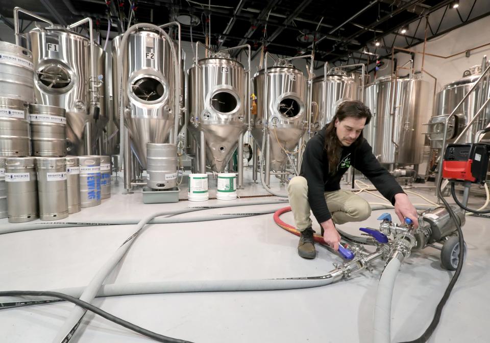Brighten Brewing Company co-owner and head brewer Tom Robbins cleans tanks at the brewery's headquarters in Copley.