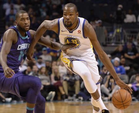 Dec 6, 2017; Charlotte, NC, USA; Golden State Warriors forward Kevin Durant (35) drives against Charlotte Hornets forward Michael Kidd-Gilchrist (14) during the first half at the Spectrum Center. Mandatory Credit: Sam Sharpe-USA TODAY Sports