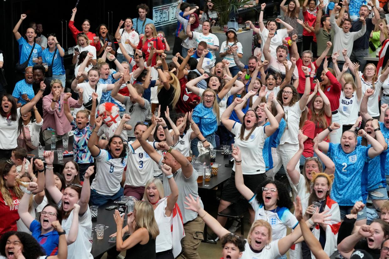 England fans cheer as England score their first goal at the screening of the Women's World Cup 2023 semifinal soccer match between England and Australia at BOXPARK Wembley in London, Wednesday, Aug. 16, 2023. (AP Photo/Frank Augstein)