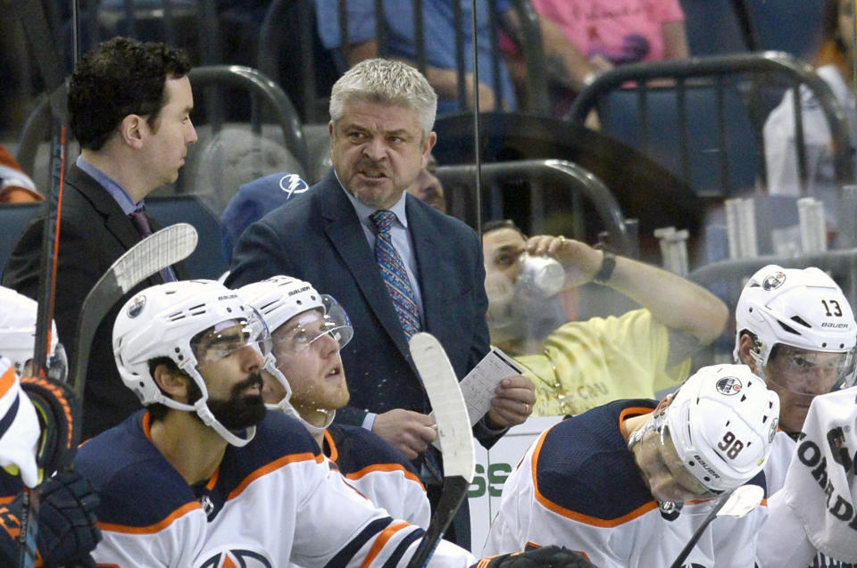 FILE - In this March 18, 2018, file photo, Edmonton Oilers head coach Todd McLellan is shown during the third period of an NHL hockey game against the Tampa Bay Lightning, in Tampa, Fla. The Oilers have fired coach Todd McLellan and replaced him with Ken Hitchcock with the team languishing in sixth place in the Pacific Division. McLellan was in his fourth season behind the Oilers' bench. The team missed the playoffs in two of his previous three seasons despite having superstar Connor McDavid on its roster. The Oilers were just 9-10-1 entering its game Tuesday night, Nov. 20, 2018, at San Jose.(AP Photo/Jason Behnken, File)