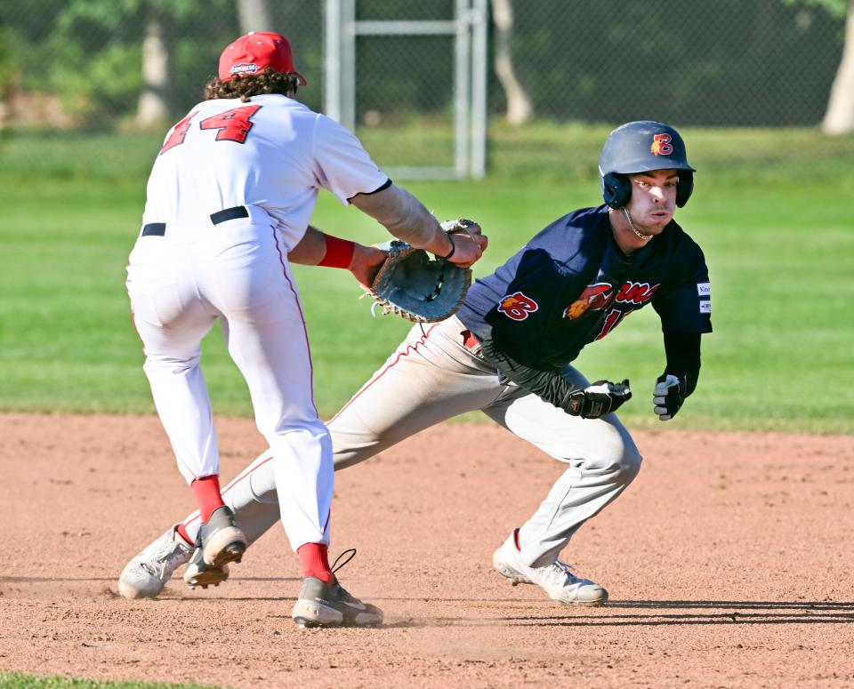 Jack Hurley of Bourne avoids the tag in a run down between first and second by Y-D first baseman Luke Franzoni in Cape League baseball at Y-D. He was eventually caught by pitcher Garrett Gainous. For a photo gallery: https://www.capecodtimes.com/news/photo-galleries/