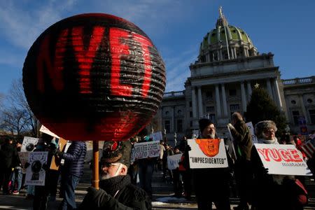 People protest against U.S. President-elect Donald Trump as electors gather to cast their votes for U.S. president at the Pennsylvania State Capitol in Harrisburg, Pennsylvania, U.S. December 19, 2016. REUTERS/Jonathan Ernst