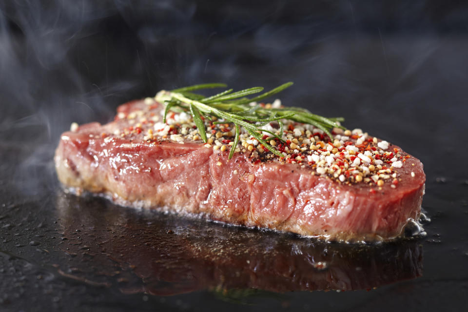 A steak on a hot pan.