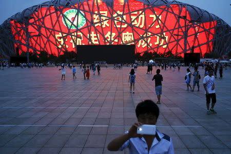 A message of congratulation is projected onto the Bird's Nest Olympic stadium as people celebrate after Beijing was chosen to host the 2022 Winter Olympics in Beijing July 31, 2015. REUTERS/Damir Sagolj