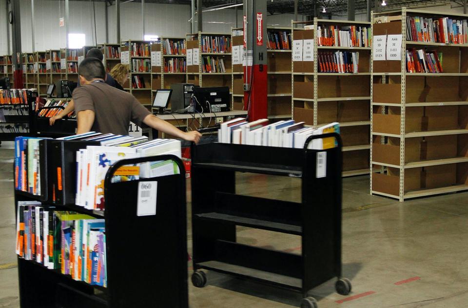 Employees restock returned textbooks at the Chegg Inc. warehouse in Shepherdsville, Kentucky, U.S., on Thursday, April 29, 2010. (Photo: John Sommers II/Bloomberg via Getty Images)