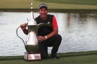 Australia's Lucas Herbert celebrates with his trophy after he won the Dubai Desert Classic golf tournament in Dubai, United Arab Emirates, Sunday, Jan. 26, 2020. (AP Photo/Kamran Jebreili)