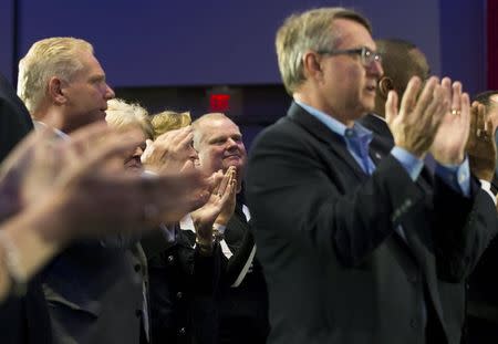 Former Toronto Mayor and current city councillor Rob Ford clap with his brother Doug (L) during Canada's Prime Minister and Conservative leader Stephen Harper's rally in Toronto, Ontario, October 17, 2015. REUTERS/Mark Blinch