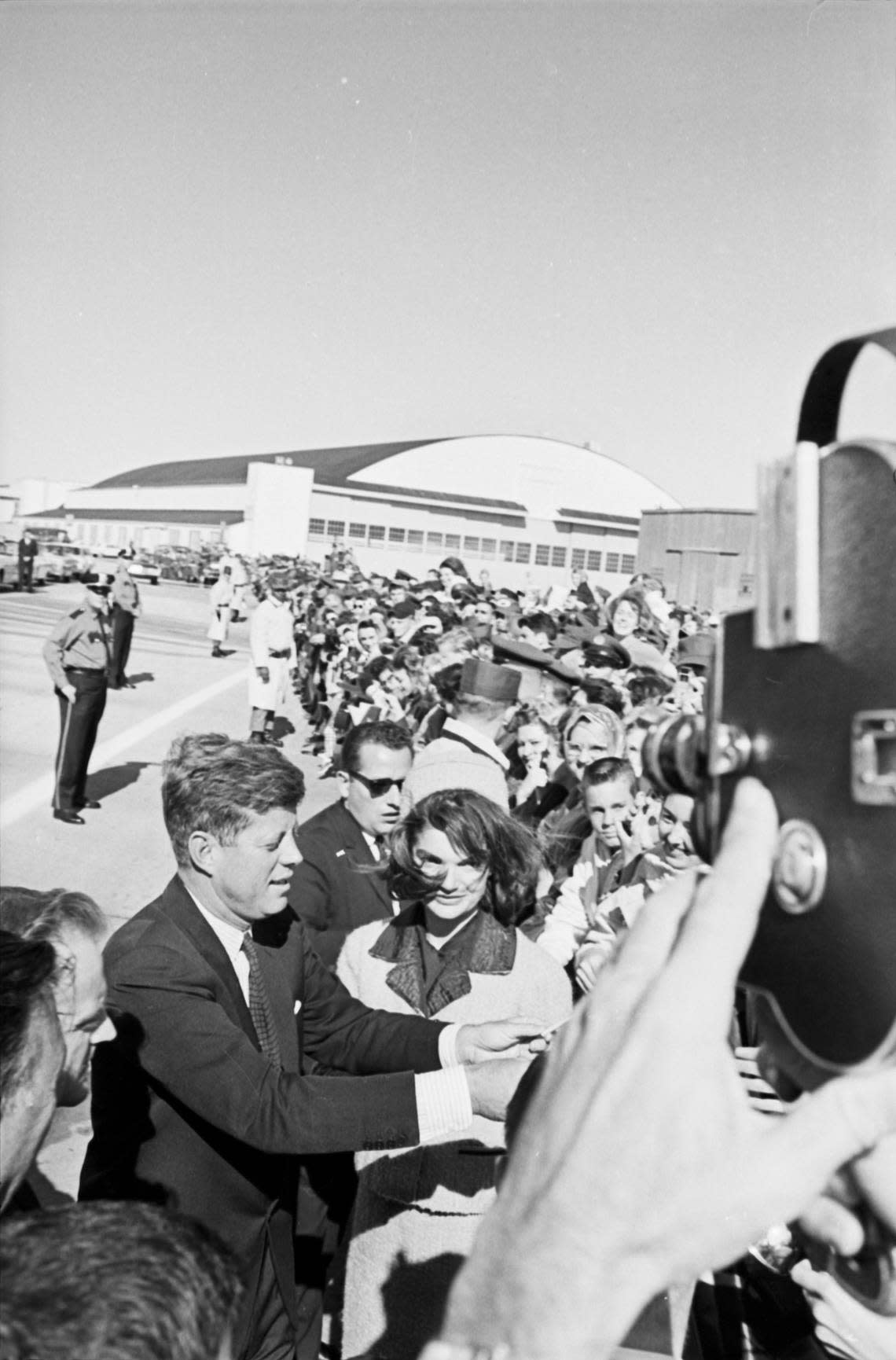 President John F. Kennedy with Jackie Kennedy signing autographs at Carswell Air Force Base in Fort Worth on their way to Dallas Love Field. Nov. 22, 1963