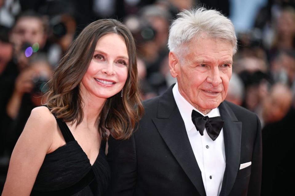 Calista Flockhart and Harrison Ford attend the "Indiana Jones And The Dial Of Destiny" red carpet during the 76th annual Cannes film festival at Palais des Festivals