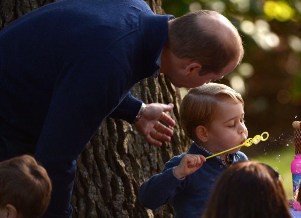 Prince George plays with bubbles as Prince William looks on during a children’s tea party at Government House in Victoria, Thursday, Sept. 29, 2016. THE CANADIAN PRESS/Jonathan Hayward