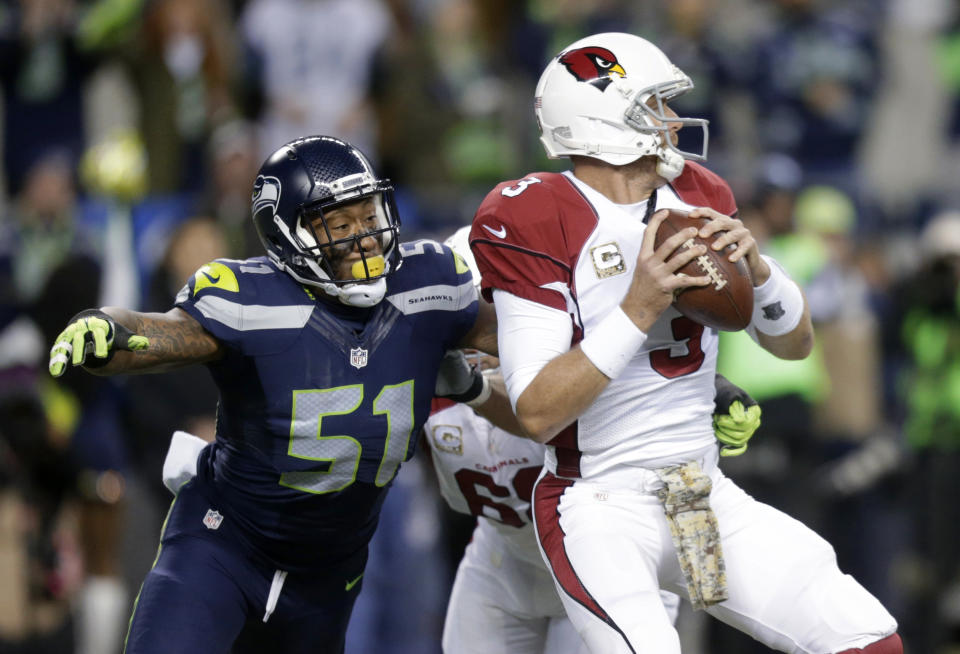 FILE - In this Nov. 15, 2015, file photo, Seattle Seahawks outside linebacker Bruce Irvin (51) pressures Arizona Cardinals quarterback Carson Palmer during the first half of an NFL football game in Seattle. Irvin is thrilled to be back where his NFL journey started. Irvin jumped at the chance to return to Seattle this offseason, but his reunion with the Seahawks comes with the expectation he can help a lackluster pass rush. (AP Photo/Stephen Brashear, File)