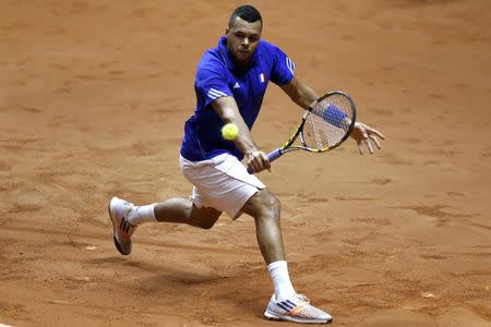 France's Jo-Wilfried Tsonga returns the ball to Switzerland's Stanislas Wawrinka during their Davis Cup final singles tennis match at the Pierre-Mauroy stadium in Villeneuve d'Ascq, near Lille, November 21, 2014. REUTERS/Pascal Rossignol