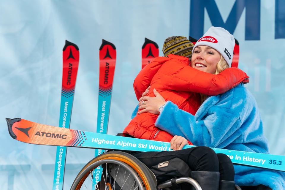 Mikaela Shiffrin hugs a young fan at the Vail celebration.