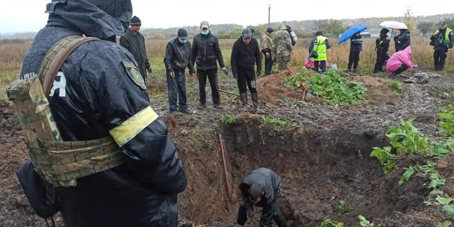 Russians dumped bodies into a pit, covered with soil, rolled it flat with tanks