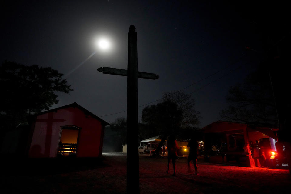 Members of the Kalunga quilombo, the descendants of runaway slaves, arrive in the early evening to participate at the end of the week-long pilgrimage and celebration of "Nossa Senhora da Abadia" in the rural area of Cavalcante, Goias state, Brazil, Friday, Aug. 12, 2022. Followers of the community's patron saint, Our Lady of Abadia, celebrate at this time of the year with weddings, baptisms and by crowning distinguished community members, as they maintain cultural practices originating from Africa that mix with Catholic traditions. (AP Photo/Eraldo Peres)