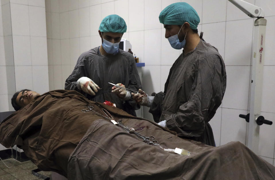 A man is treated at a hospital after a deadly attack at Kabul University, in Kabul, Afghanistan, Monday, Nov. 2, 2020. The brazen attack by gunmen who stormed the university has left many dead and wounded in the Afghan capital. The assault sparked a hours-long gunbattle. (AP Photo/Rahmat Gul)