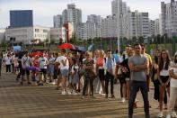 People queue to cast their votes in the Belarusian presidential election in Minsk, Belarus, Sunday, Aug. 9, 2020. Belarusians are voting on whether to grant incumbent president Alexander Lukashenko a sixth term in office, extending his 26-years rule, following a campaign marked by unusually strong demonstrations by opposition supporters. (AP Photo/Sergei Grits)