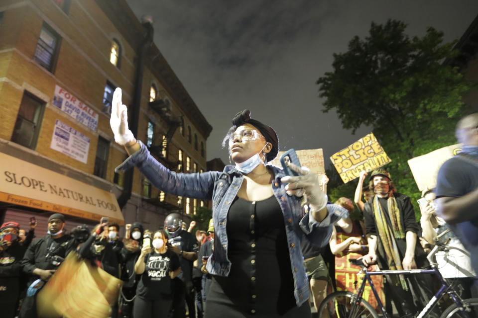 FILE - Protestors confront Police Officers near Barclays Center after a rally over the death of George Floyd, Friday, May 29, 2020, in the Brooklyn borough of New York. The massive protests sweeping across U.S. cities following the police killing of a black man in Minnesota have elevated fears of a new surge in cases of the coronavirus. Images showing thousands of screaming, unmasked protesters have sent shudders through the health community, who worry their calls for social distancing during the demonstrations are unlikely to be heard. (AP Photo/Frank Franklin II)