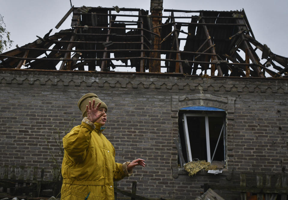 Local resident Victoria, 57, reacts next to her residential building that was damaged after an overnight Russian attack in Kramatorsk, Ukraine, Tuesday, Oct. 4, 2022. (AP Photo/Andriy Andriyenko)