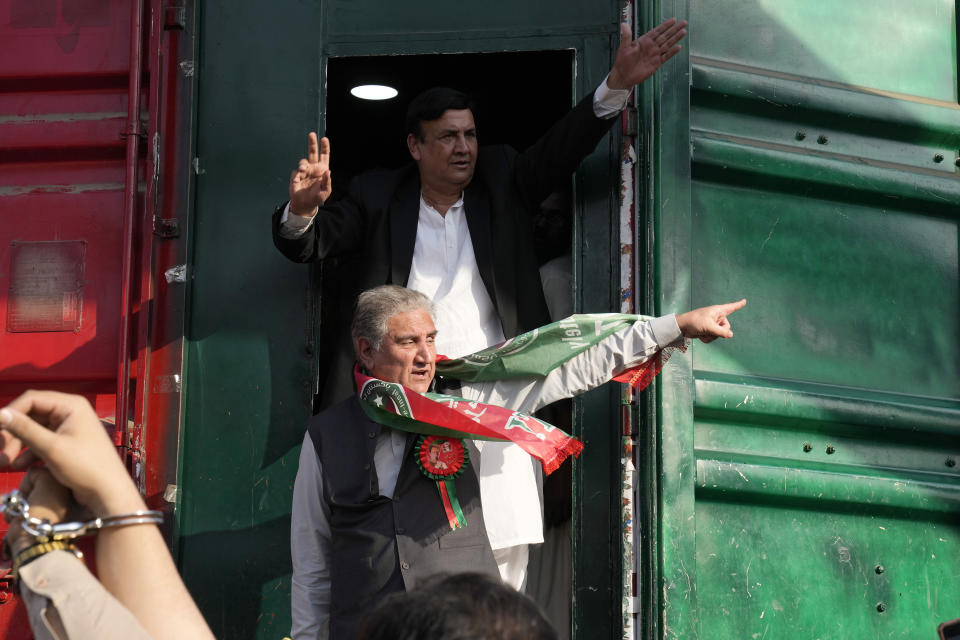 Shah Mahmood Qureshi, bottom center, a senior leader of Pakistan's former prime minister Imran Khan's 'Pakistan Tehreek-e-Insaf' party takes part in a rally, in Lahore, Pakistan, Wednesday, Feb. 22, 2023. Hundreds of supporters of Pakistan's former prime minister on Wednesday defied a ban on rallies in a commercial area of the city of Lahore, taunting police and asking to be arrested en masse. (AP Photo/K.M. Chaudary)