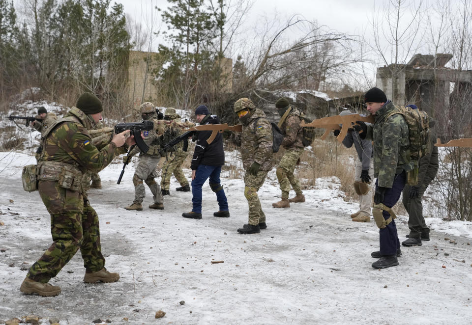An instructor trains members of Ukraine's Territorial Defense Forces, close to Kyiv, Ukraine, Saturday, Jan. 29, 2022. Dozens of civilians have been joining Ukraine's army reserves in recent weeks amid fears about Russian invasion. (AP Photo/Efrem Lukatsky)
