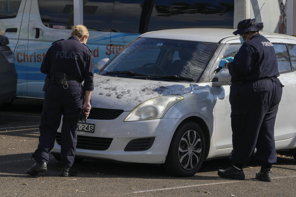 Police forensic officers inspect a car outside the Christ the Good Shepherd Church in suburban Wakely in western Sydney, Australia, Tuesday, April 16, 2024. Australian police say a knife attack in Sydney that wounded a bishop and a priest during a church service as horrified worshippers watched online and in person, and sparked a riot was an act of terrorism. (AP Photo/Mark Baker)