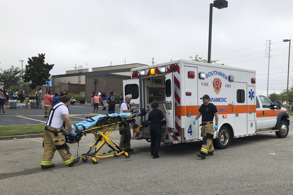 Medical staff stage outside a Walmart store, Tuesday, July 30, 2019, in Southaven, Miss. Officials say at least two people are dead and a police officer and a suspect were shot at the Walmart in the northern Mississippi city town, a suburb of Memphis, Tenn. (Photo: Adrian Sainz/AP)