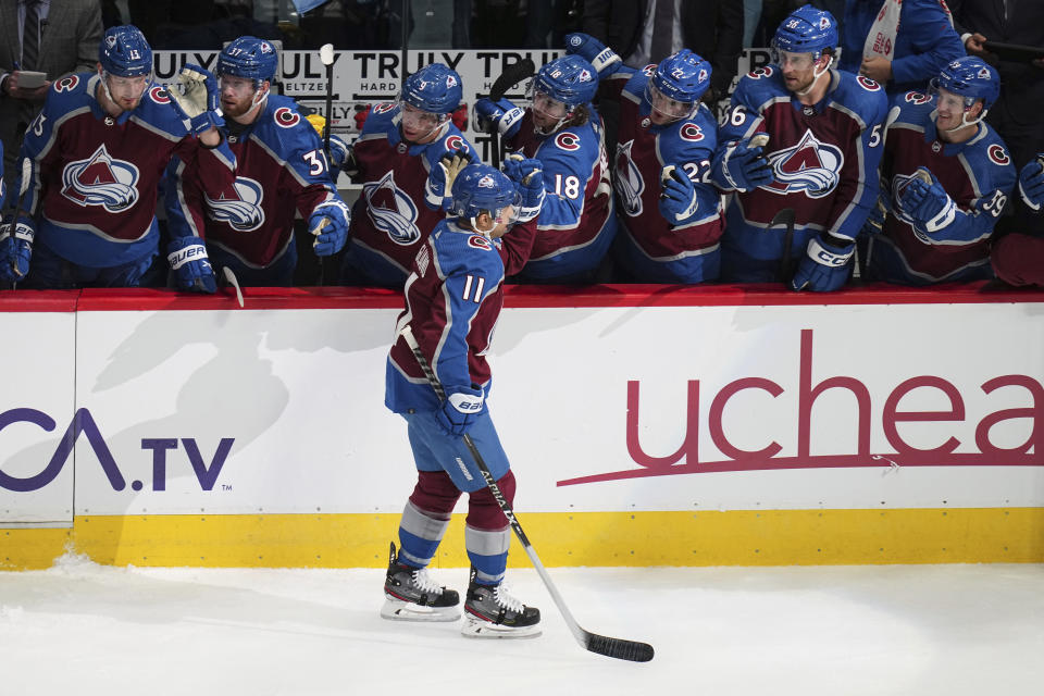 Colorado Avalanche center Andrew Cogliano (11) is congratulated for a goal against the Chicago Blackhawks during the first period of an NHL hockey game Wednesday, Oct. 12, 2022, in Denver. (AP Photo/Jack Dempsey)