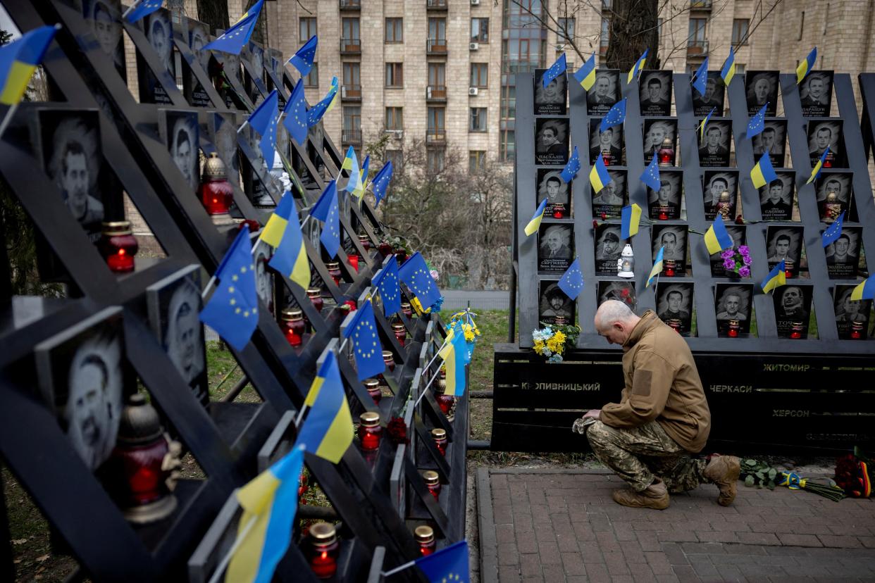 A soldier pays his respects at the monument to the so-called ‘Heavenly Hundred’, the people killed during the Ukrainian pro-European Union (EU) mass demonstrations in 2014 (REUTERS)
