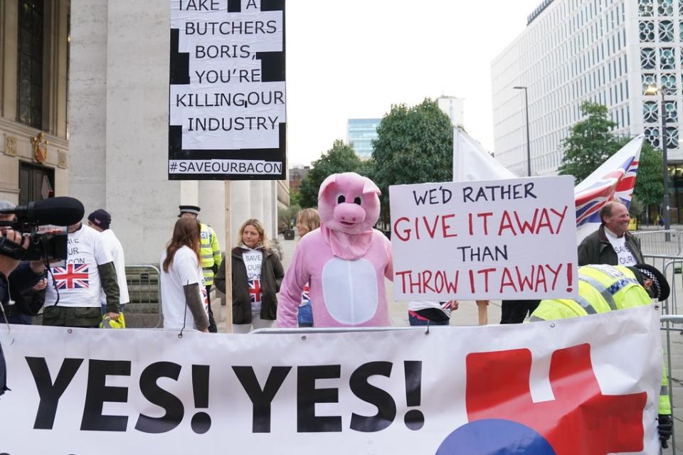 Pig farmers protesting outside the Conservative Party conference in Manchester (Stefan Rousseau/PA) (PA Wire)