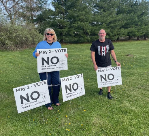 Kim and Jeff Hayes of Berkshire Township display some of the signs that urged township residents to vote "no" on a May 2, 2023, primary referendum on whether to rezone about 88 acres on Plumb and Dustin roads in the township. Voters rejected the referendum, a sign of the concerns about growth facing municipal candidates in Delaware County in the November general election.