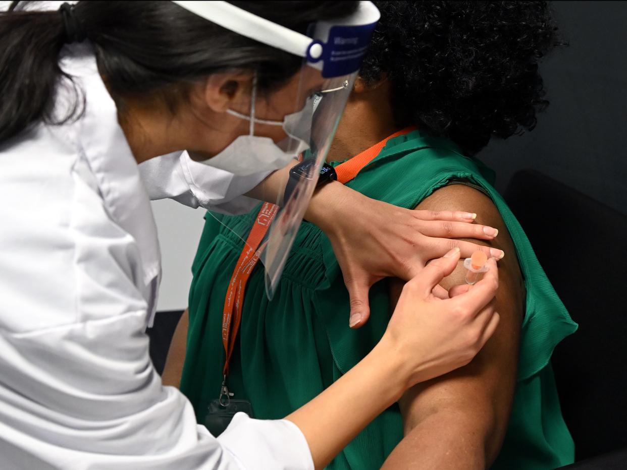 Care worker Felicia Melody gets vaccinated with the Oxford-AstraZeneca covid vaccine at the Med Mart pharmacy (Getty Images)