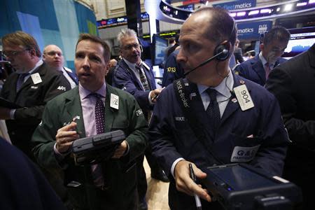 Traders work on the floor of the New York Stock Exchange at the opening of the trading session in New York October 5, 2012. REUTERS/Mike Segar